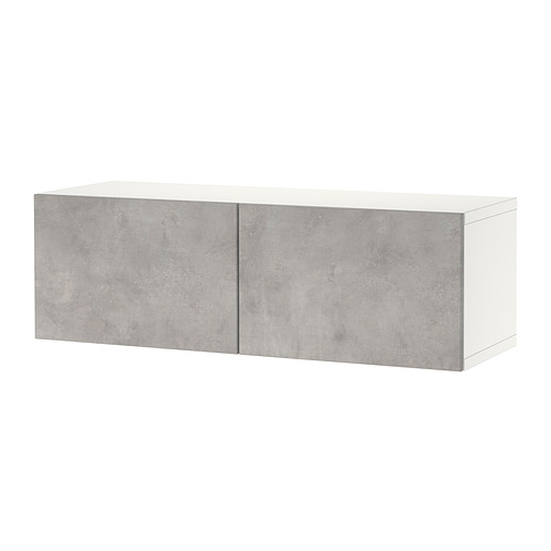 Muebles BESTÅ en color blanco con puertas efecto cemento gris. Mueble rectangular con dos grandes puertas.