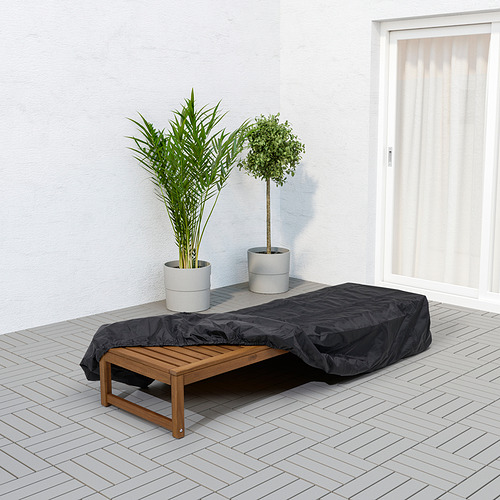 Salón exterior cubierto en el patio con dos plantas en macetas cerca, que brindan protección contra los elementos.