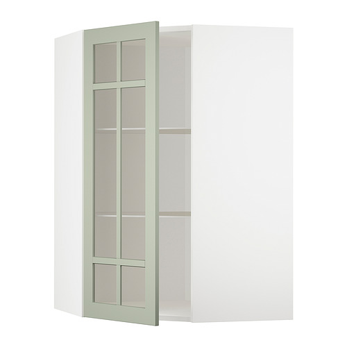 Un armario esquinero METOD verde con puertas de cristal y estantes ajustables.