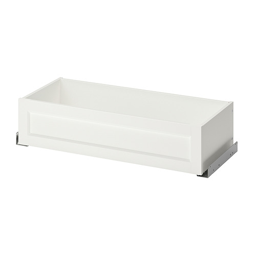 Un cajón de armario blanco KOMPLEMENT con un diseño elegante, con un frente enmarcado, deslizadores metálicos y una forma rectangular limpia.