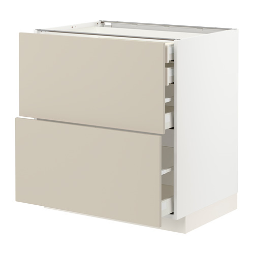 Un mueble de cocina blanco y beige del sistema METOD, con dos cajones grandes y un cajón mediano.