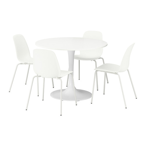 IKEA DOCKSTA: juego de comedor redondo blanco con 4 sillas apilables. Estructura metálica minimalista y respaldos curvos, ideal para espacios pequeños.