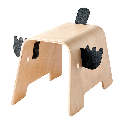 Un juguete de madera, GREJSIMOJS, con forma de elefante con detalles de fieltro. Es beige y negro, diseñado con curvas sencillas y aptas para niños.