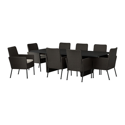 Juego de comedor de exterior de mimbre negro con 8 sillas y mesa rectangular, ideal para uso en el patio.