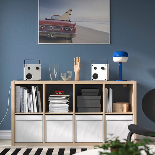 Habitación moderna con pared azul, foto de coche rojo, estantería, altavoces VAPPEBY.