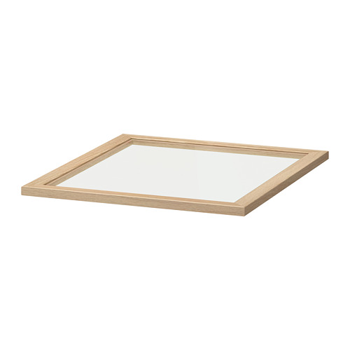 Un estante de cristal KOMPLEMENT de ikea en color transparente. Su forma cuadrada tiene una estructura de madera de color beige claro y está fabricada en tableros de fibra y vidrio templado.
