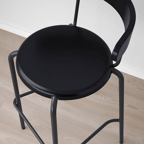 Moderno taburete de bar negro con un diseño elegante y curvo. Un asiento redondo y estructura compacta, ideal para espacios reducidos.