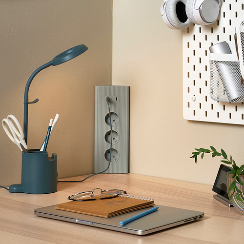 Elegante configuración de escritorio con cable SKOTAT azul, computadora portátil, computadora portátil y planta.