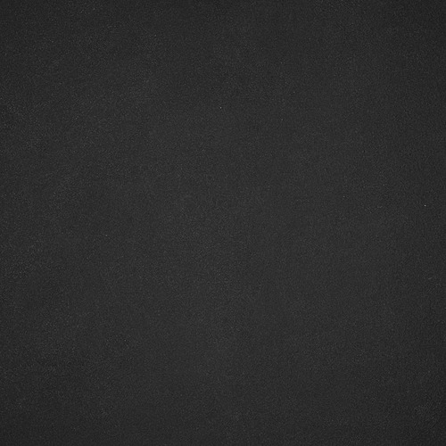 Superficie porcelánica negra, lisa, de alta calidad y textura uniforme, que refleja la mínima luz.