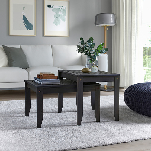 Mesas modernas de madera de acacia negras, anidadas, tamaño compacto, sofá blanco, alfombra gris, estampados de hojas.