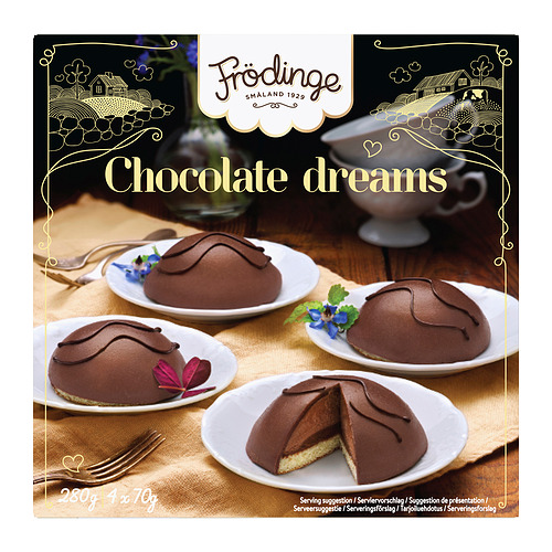 Imagen FRÖDINGE sueños de chocolate postres en platos con tenedores. Un postre está cortado, revelando el interior.