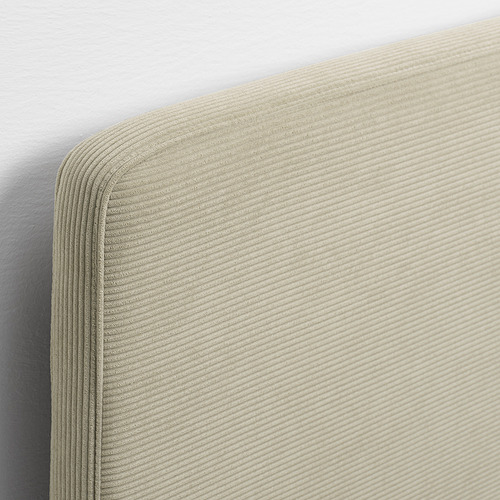 Primer plano de la estructura de la cama moderna con cabecero de tela acanalada beige; Textura suave y cómoda y costuras limpias.