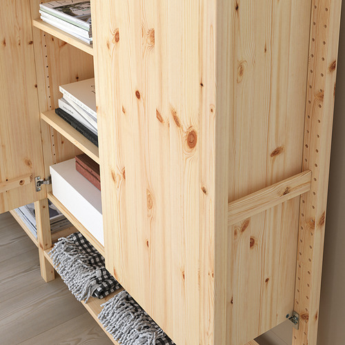 Mueble de almacenamiento de madera con múltiples estantes parcialmente llenos de libros. El diseño modular permite ajustar el espacio entre los estantes.