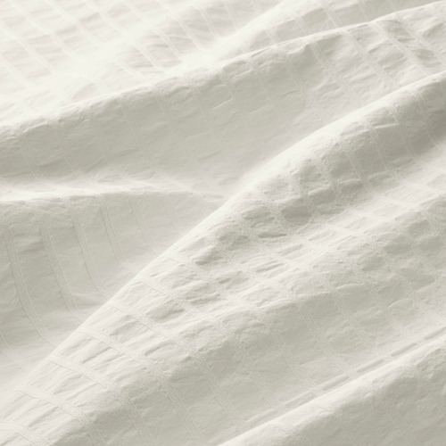 Primer plano de una lujosa funda nórdica texturizada que muestra un tejido ligero, nítido y cómodo.