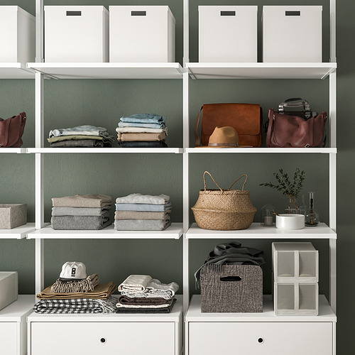 Estantería con ropa, bolsos y cajas de almacenamiento cuidadosamente doblados, que muestran un almacenamiento organizado.