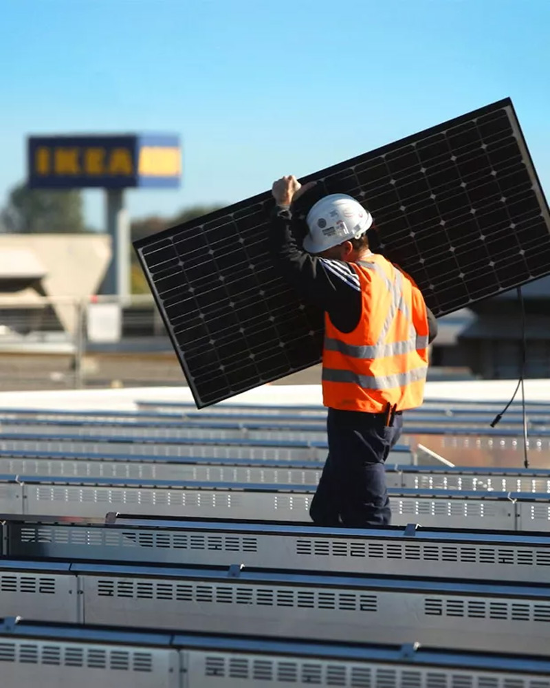 A worker moving a solar panel