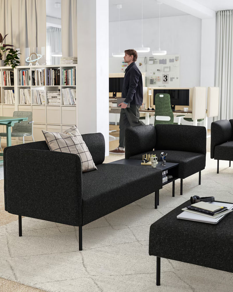 Modern office waiting room with black sofas and armchairs in modern and elegant style