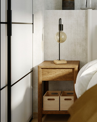 a bedside table with a lamp and a sliding door