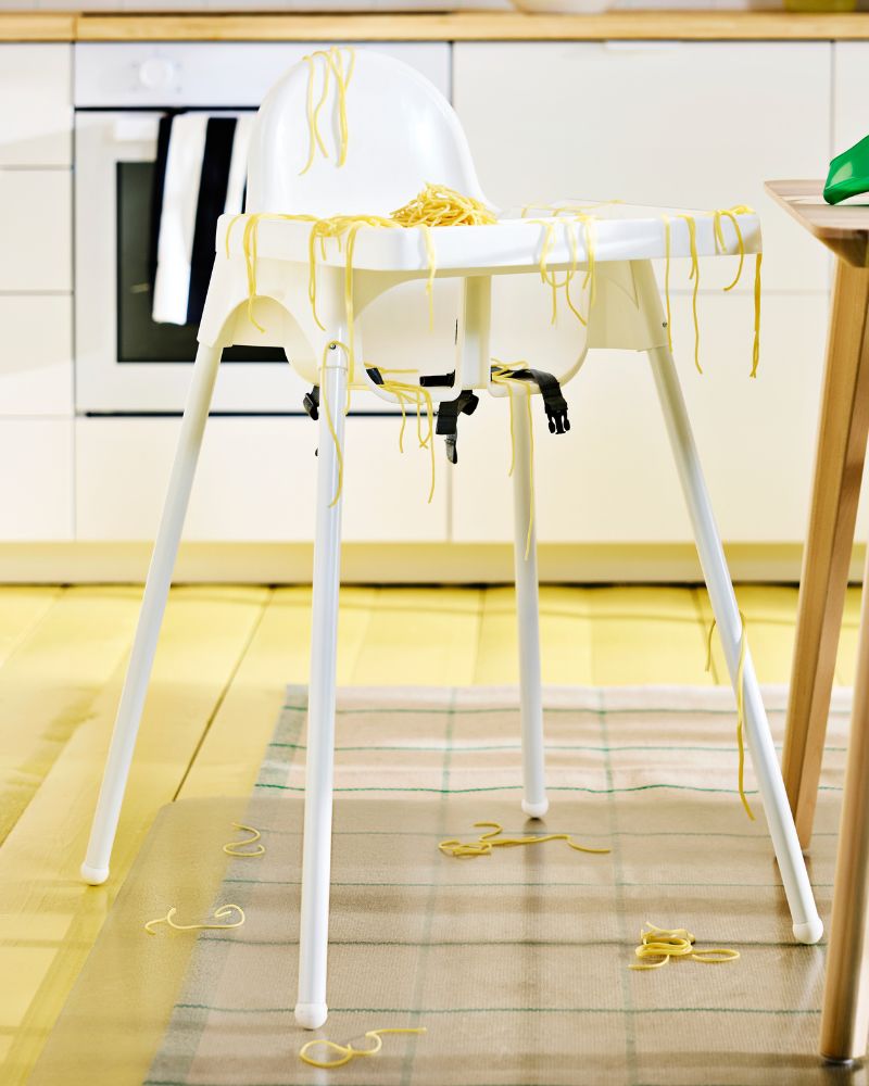 White baby ANTILOP highchair with safety straps in modern kitchen setting.