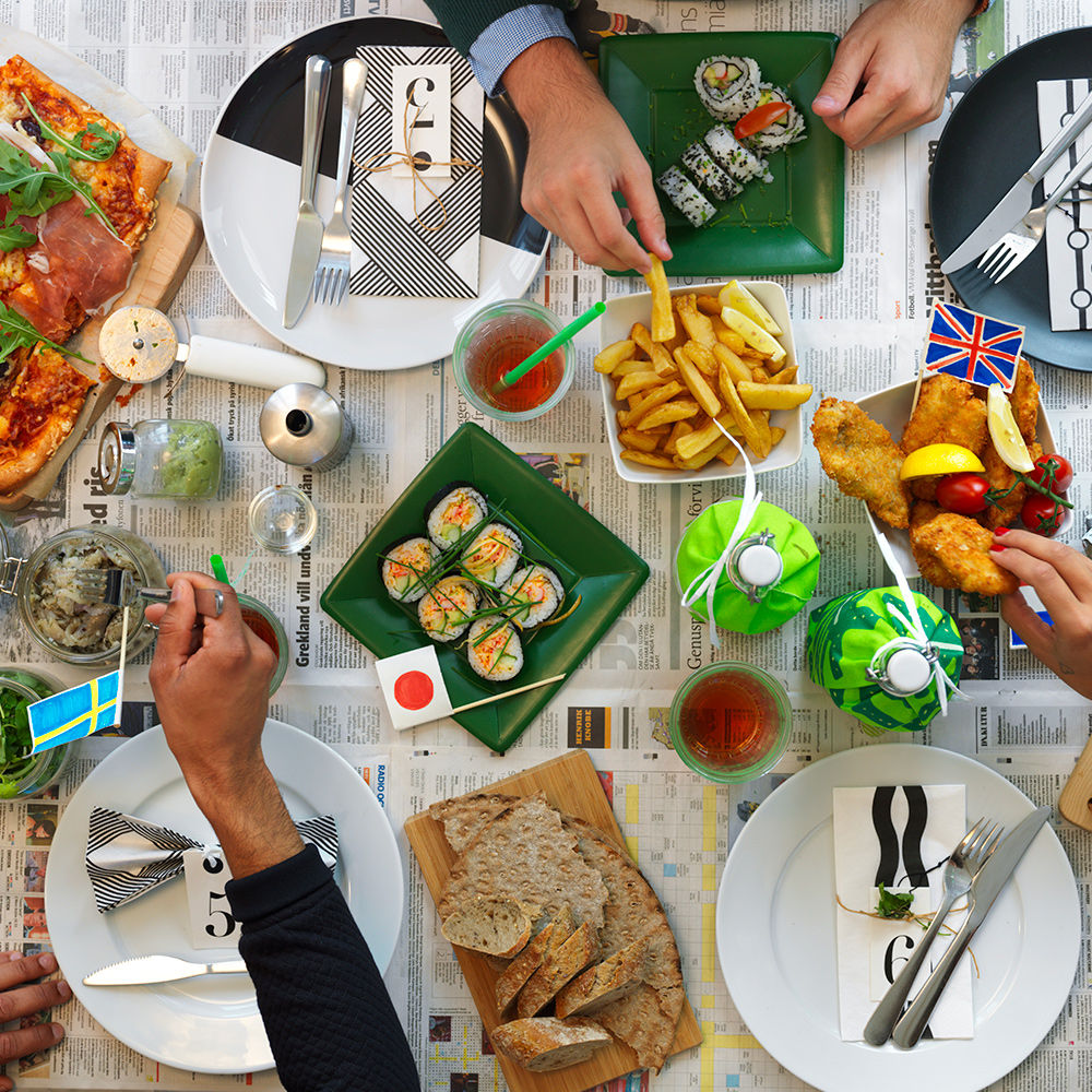 Table featuring IKEA menu recipes with the BEHAGFULL cutlery set, OFTAST plates, KORKEN jar with lid, and APTILIG chopping board.
