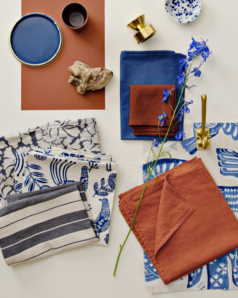 A swatch of BITTERSÖTA pre-cut fabric in beige and blue, displayed alongside various decorative items and textiles.