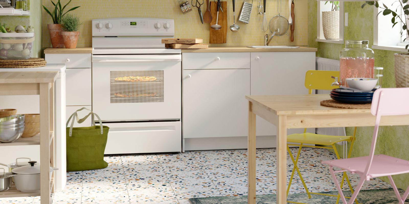Kitchen with KNOXHULT cabinets, FYNDIG sink, IKEA 365+ cookware, BEKVÄM trolley, wooden table and colorful chairs.