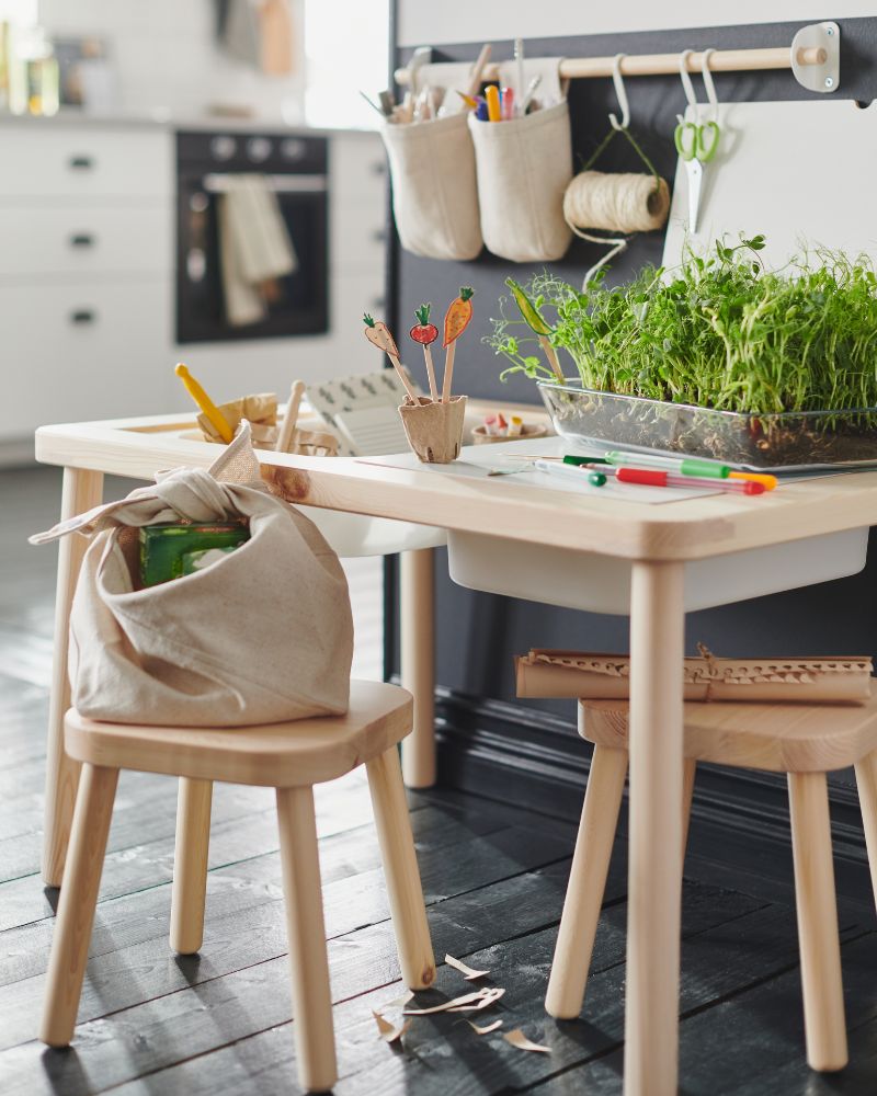 Creative playroom with FLISAT table and stool, TROFAST boxes, NEREBY rail and containers, MIXTUR dish and MÅLA scissors.