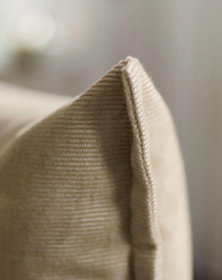 Light-colored cushion and furniture backrest .