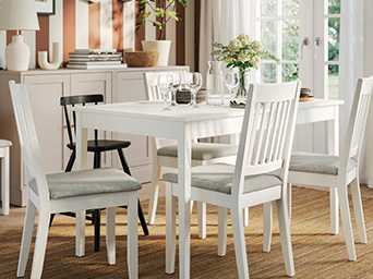 White table and chairs in bright dining room.