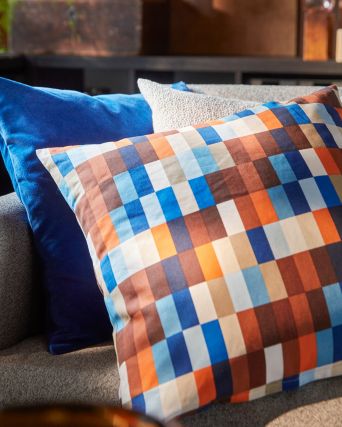 A close-up of a SALTMYRAN 3-seat sofa with a brown/blue LÖVNATURSKOG cushion cover and two other cushions.