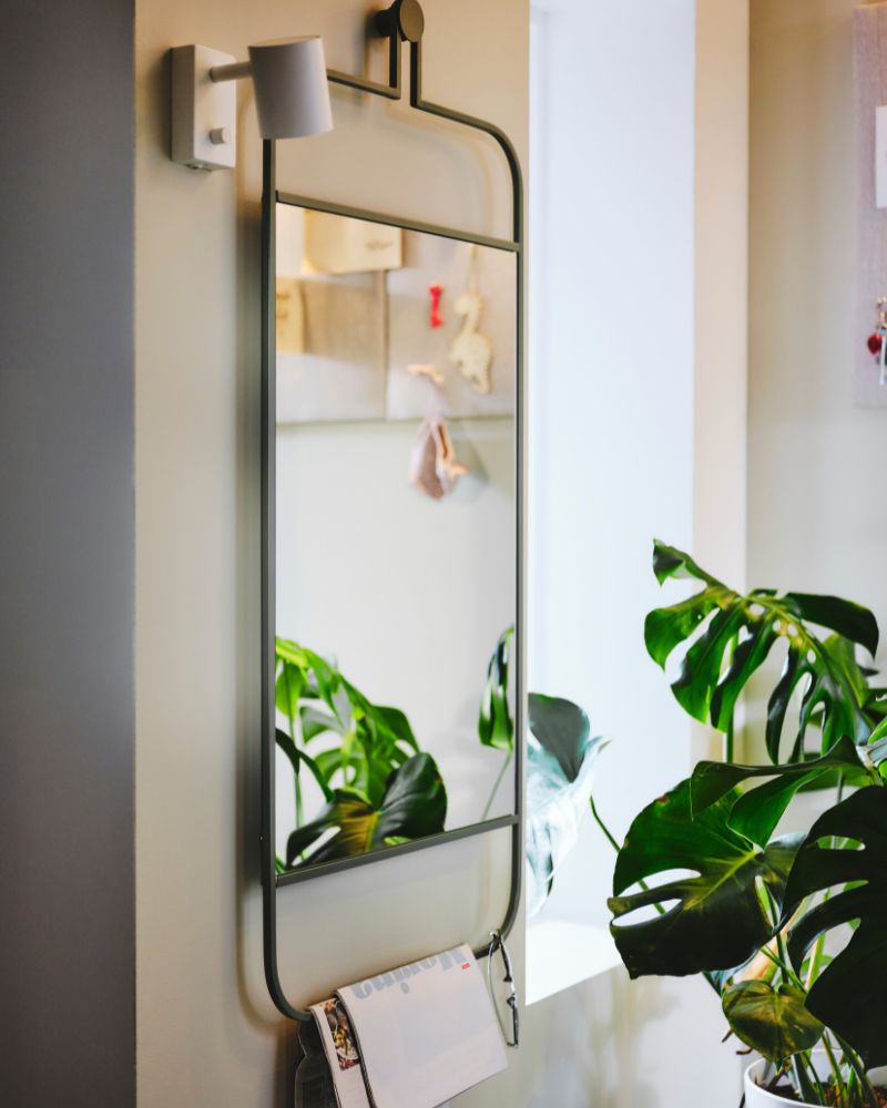 GRANVÅG mirror with integrated lower rack, paired with the NYMÅNE lamp for bright, functional wall storage.