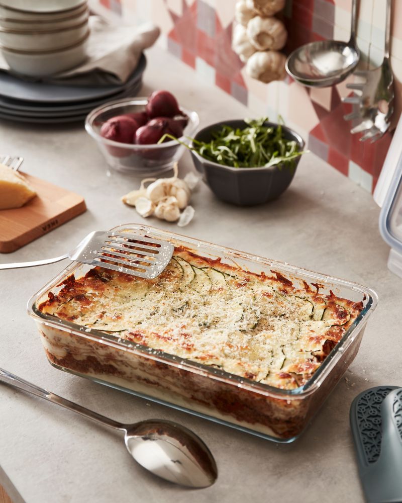 Cozy kitchen bake scene with IKEA 365+ container with lid and GRUNKA kitchen utensils alongside a freshly baked dish.