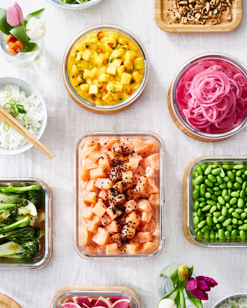 Fresh kitchen prep with IKEA 365+ lidded containers neatly filled with colorful chopped fruits and vegetables.