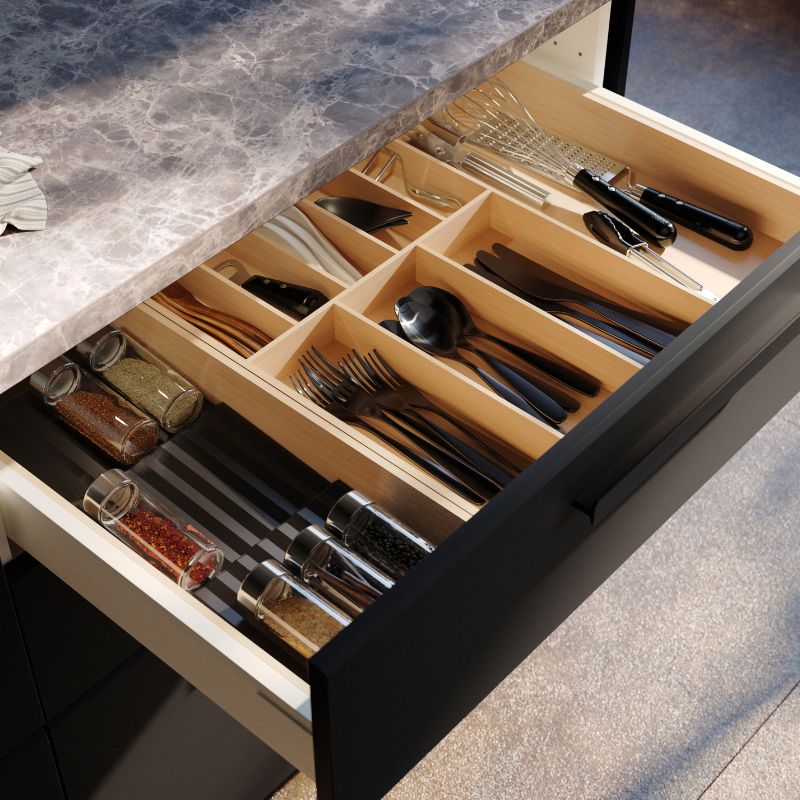 Organized kitchen drawer with IKEA UPPDATERA cutlery tray and TILLAGD cutlery sets neatly arranged for daily use.