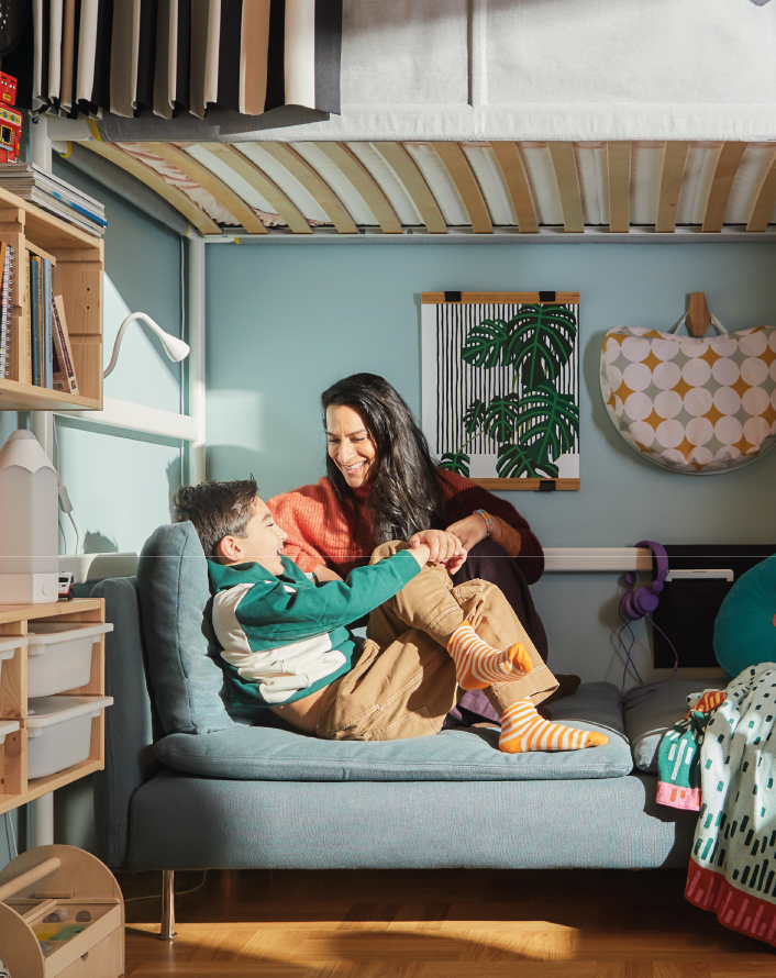 Mother and son playing on a bunk bed.
