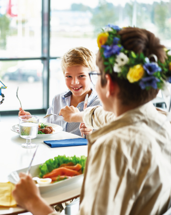 Two people sharing a meal at a table with assorted dishes.