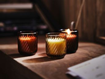 Cozy cabinet display with TONSTAD cabinet and TÖRNFÅGEL scented candles creating a warm ambient glow.