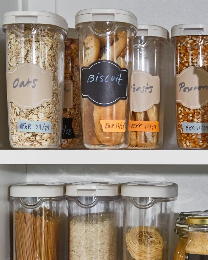 Organized pantry with IKEA 365+ containers for storing oats, pasta, biscuits and grains.