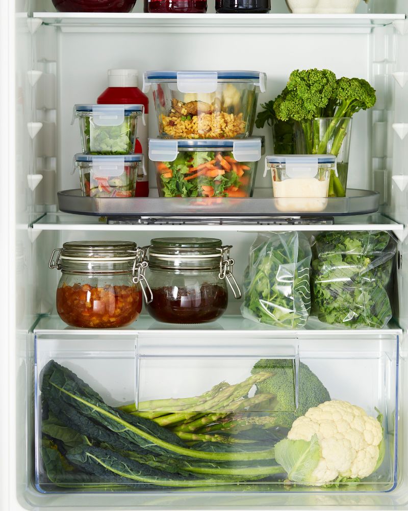 Organized refrigerator with IKEA 365+ containers, KORKEN jars and SNURRAD turntable.